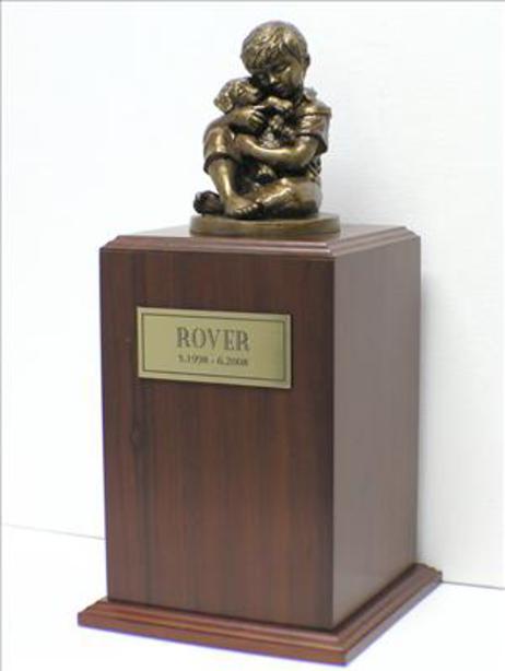 walnut urn with bronze sculpture of boy holding puppy