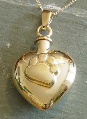 Gold Paw On My Heart cremation jewelry pendant.