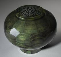 green dyed bowl shaped wood urn with celtic cross