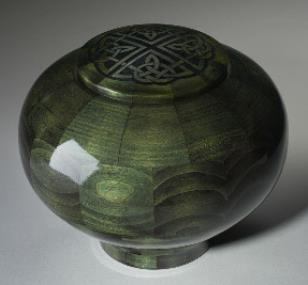 green dyed round bowl shaped wood urn with Irish cross