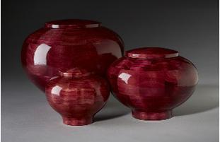 Red dyed wood cremation urns
